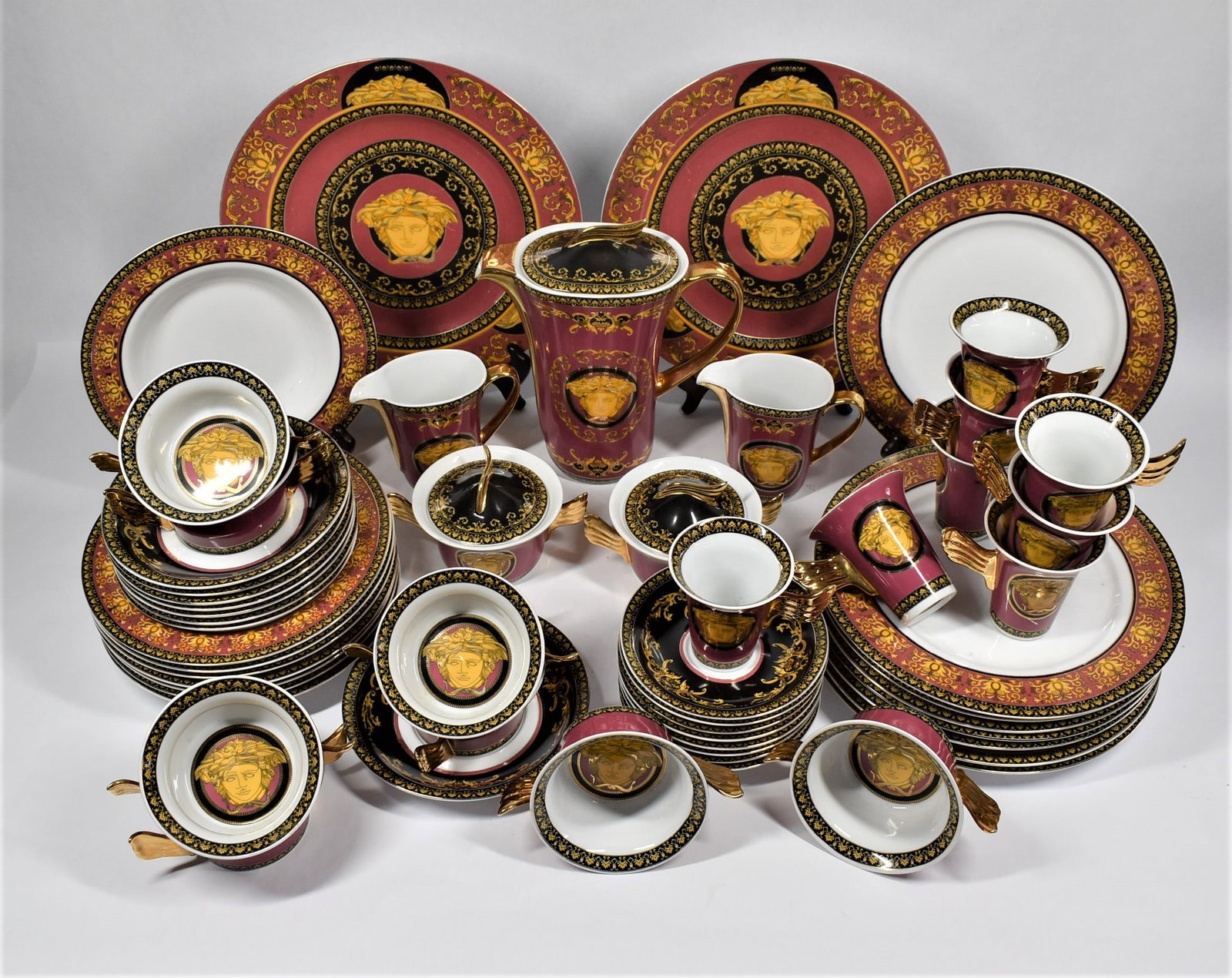 53-Piece Versace Medusa Rosenthal STYLE partial dinner service: A 53-piece Rosenthal STYLE Versace Medusa partial dinner service composed of 2 presentation plates, 8 dinner plates, 8 soup/salad plates, 1 coffee pot with cover, 2 creamers, 2 covered sugar pots, 8 b