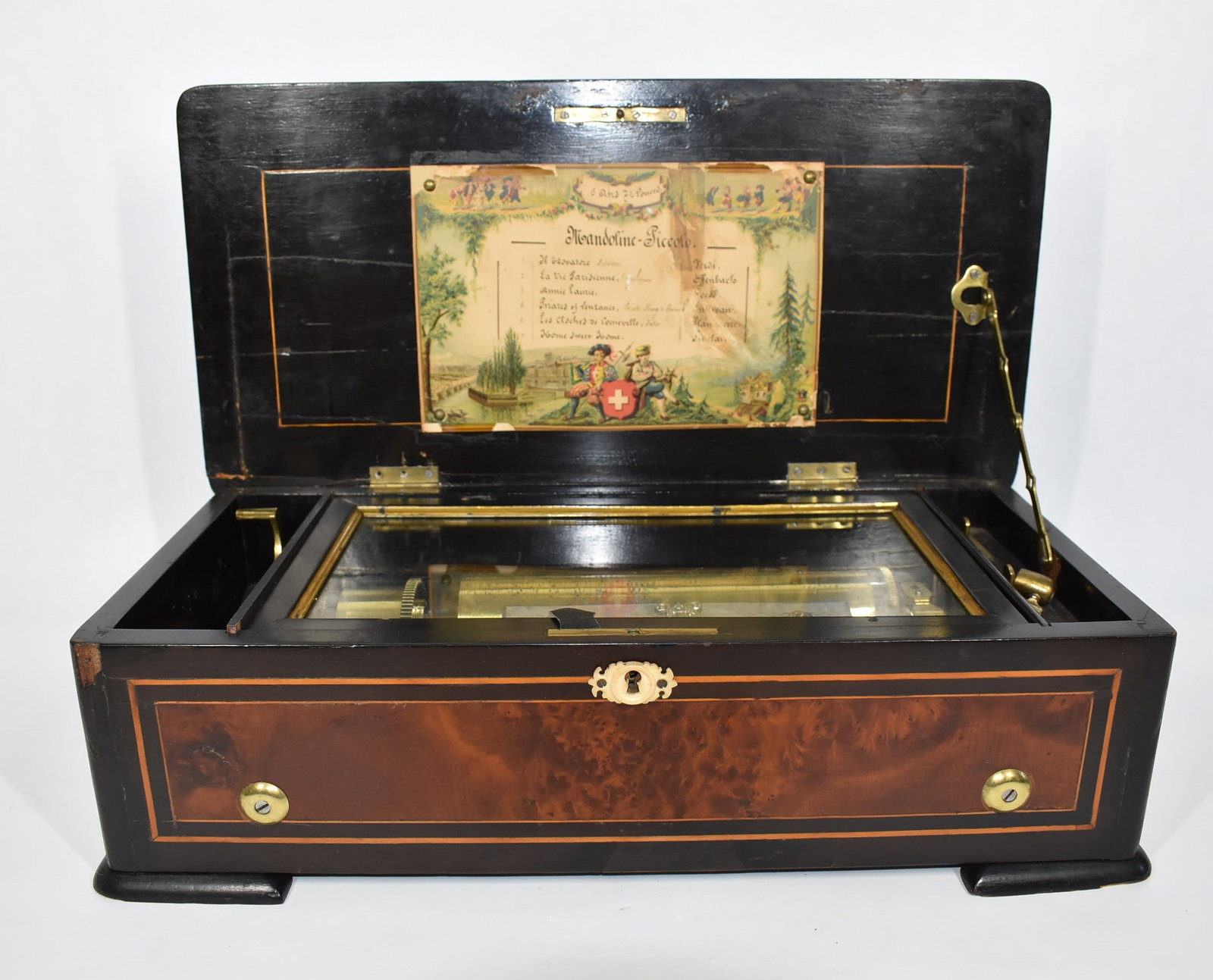 Antique Swiss 6-tune cylinder Music box: An antique Swiss six-tune cylinder music box, with footed and banded burled wood case and gilt brass handles. Numbered 12967 ( stamped on the bearing). From a Dix Hills, NY estate. 5.5"H x 18.25"L x 8