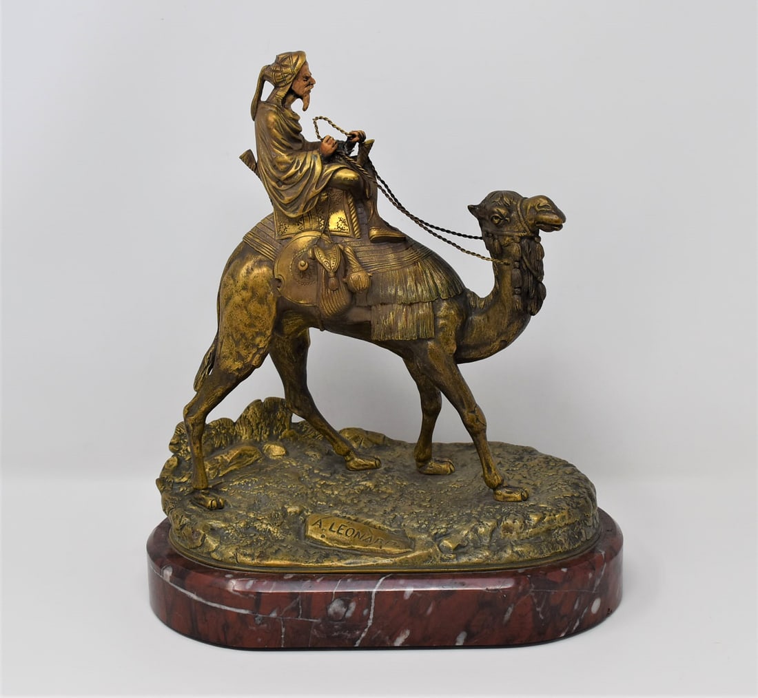Antique French Orientalist bronze of Arab on camel back signed A. Leonard: An antique French Orientalist bronze of an Arab man on camel back with gilt finish and set onto a red marble base signed A. leonard ( French, 1841-1923, Leonard Agathon Van Weydevelt) on the base. Cir