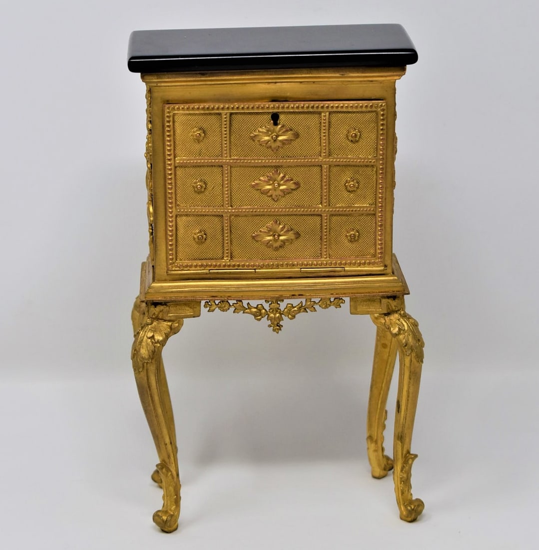 Antique French gilt bronze miniature cabinet: An antique french gilt brass miniature cabinet or " secretaire abbatant' with marble top. Apparently un-marked. Circa 1910. Approximate measurements: 7"H x 4"W x 2.25"D In-house domestic shipping is a