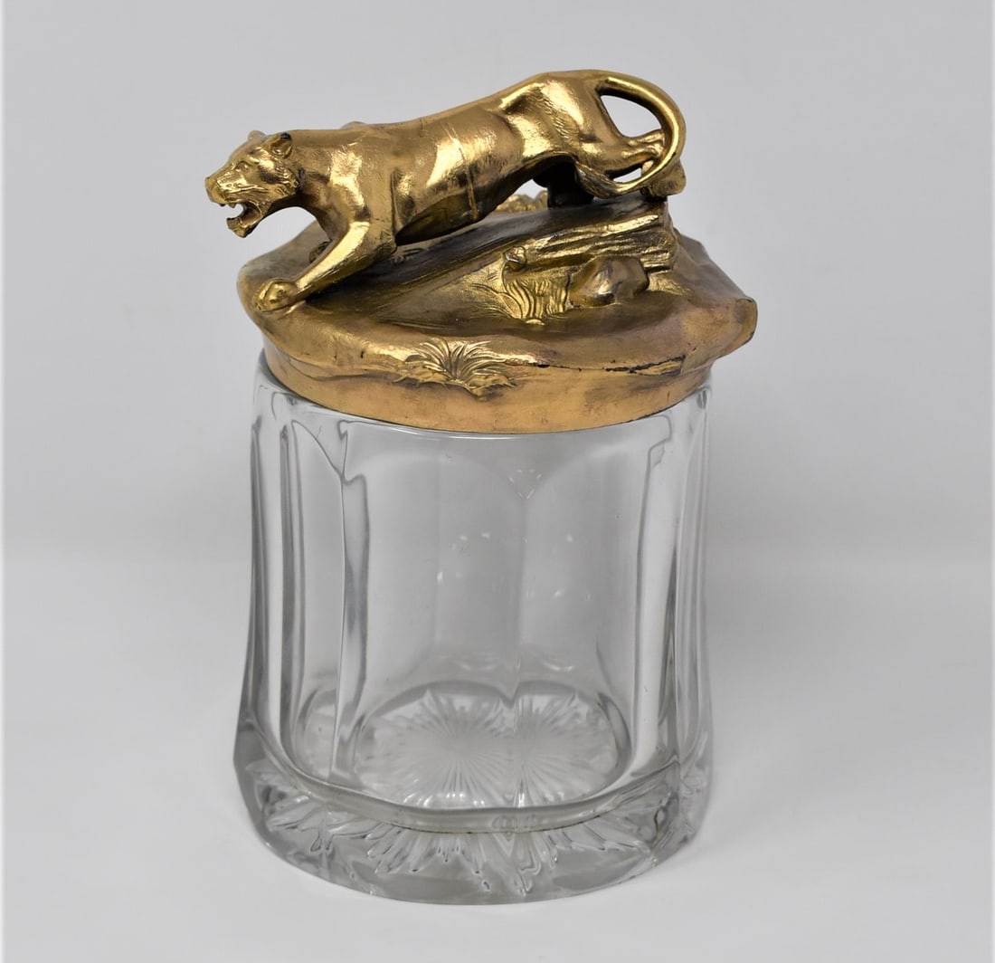 Antique SIOT Paris panther lidded jar: An antique French glass jar with gilt brass figural lid featuring a panther or lioness. Signed " Siot, Paris" on the side of the lid. Circa 1900. Approximate measurements: 7"H x 4.5" in diameter In-ho