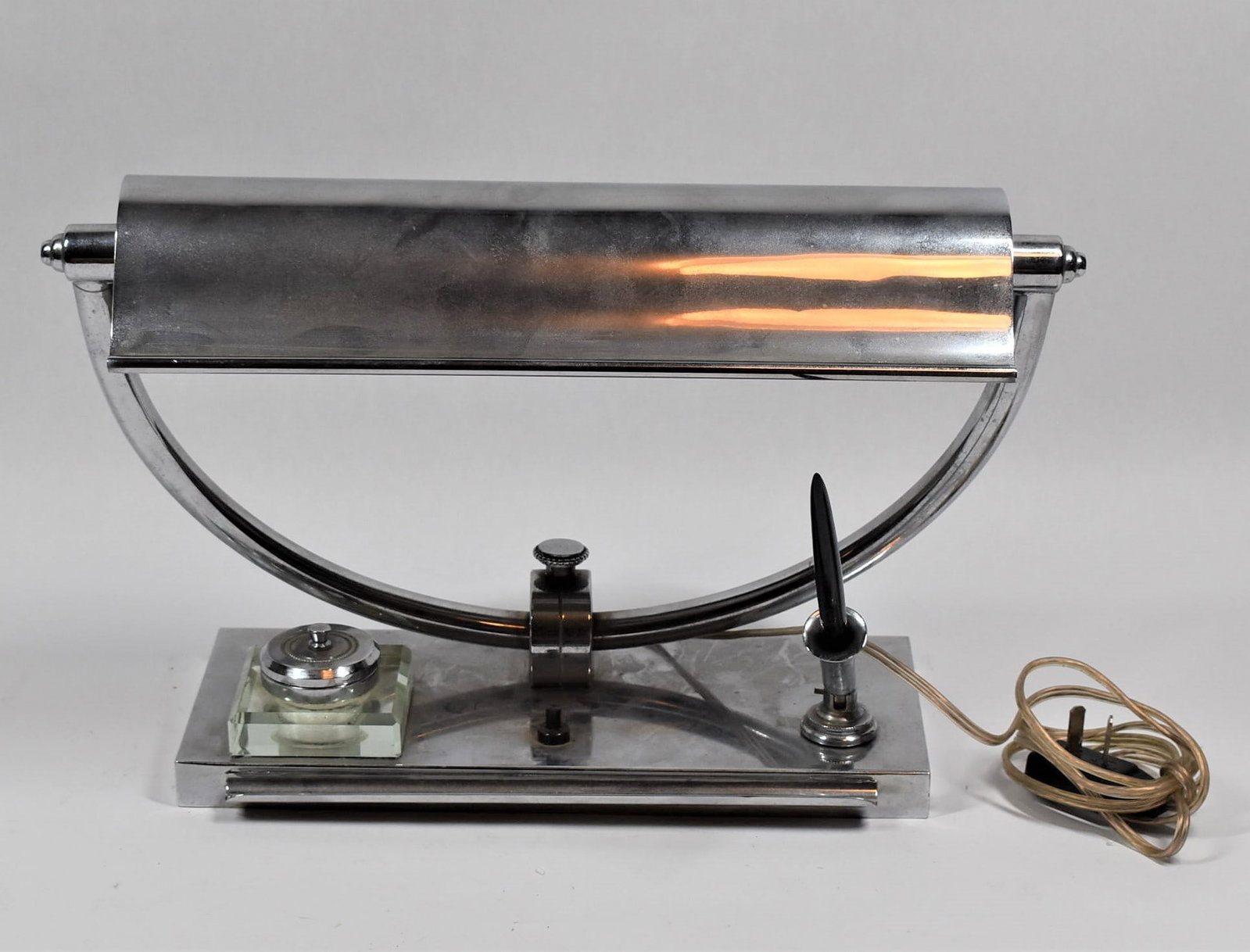 Mid-20th century chromed desk lamp / writing stand: A mid-20th century chromed metal and glass desk lamp / writing stand. Circa 1950. Approximate measurements: 9.75"H x 15.5"L x 5.5"D In-house domestic shipping is available for this lot. Shipping is of