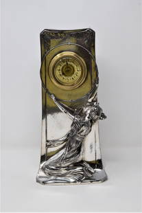 Art Nouveau silver plated figural mantel clock: An Art Nouveau period silver-plated metal figural clock. Apparently un-signed. Approximate measurements: 10.75"H x 5.25"W x 4"D In-house domestic shipping is available for this lot. Shipping is offere