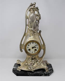 A large signed LESUEUR Art Nouveau mantel clock: A large Art Nouveau period silver plated metal mantel clock on marble base signed " Lesueur" on the bottom. France, circa 1905. Approximate measurements: 18"h x 11"W x 7"D Deker Auctions will not perf