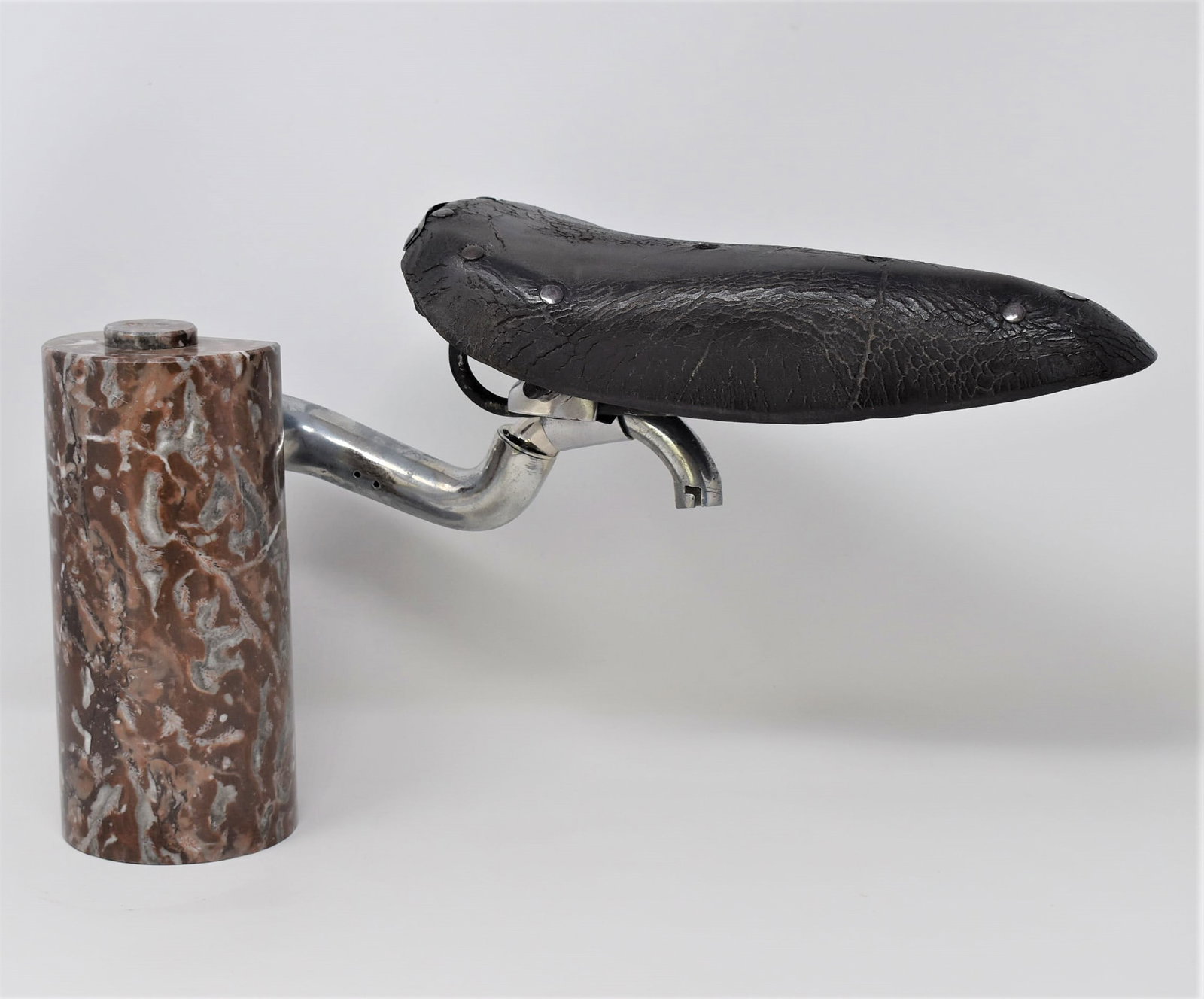 Vintage PHILIPPE THYS memorabilia bicycle seat mounted on marble base: A vintage Phillipe Thys ( Philippe Thys (1889–1971), Belgian cyclist) memorabilia, race bicycle seat later mounted on a marble base. Philippe Thys won the Tour de France three times: 1913, 1914, and