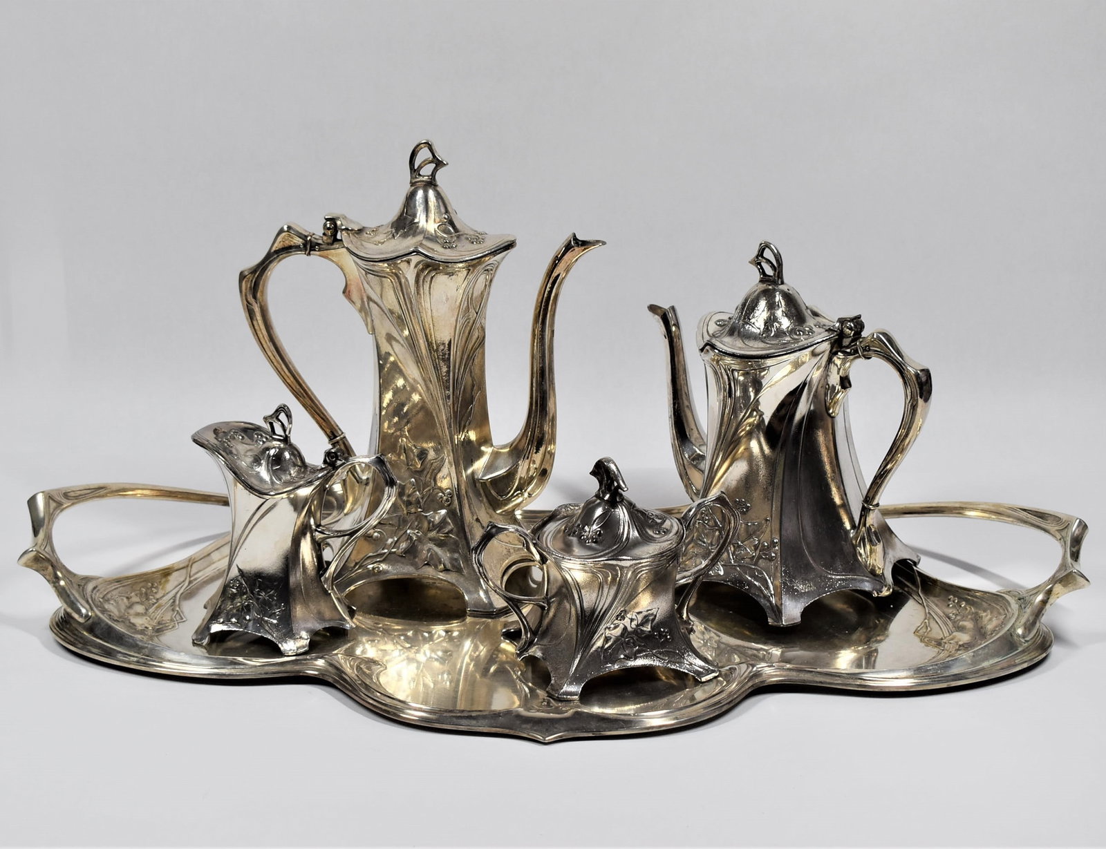Art Nouveau silvered pewter five-piece " Ivy" tea set by WMF: A beautiful Art Nouveau silvered pewter five-piece " Ivy" tea set by WMF, comprising a teapot, coffee pot, cream jug, lidded sugar bowl and a two handled tray, each decorated with ivy leaves and styli