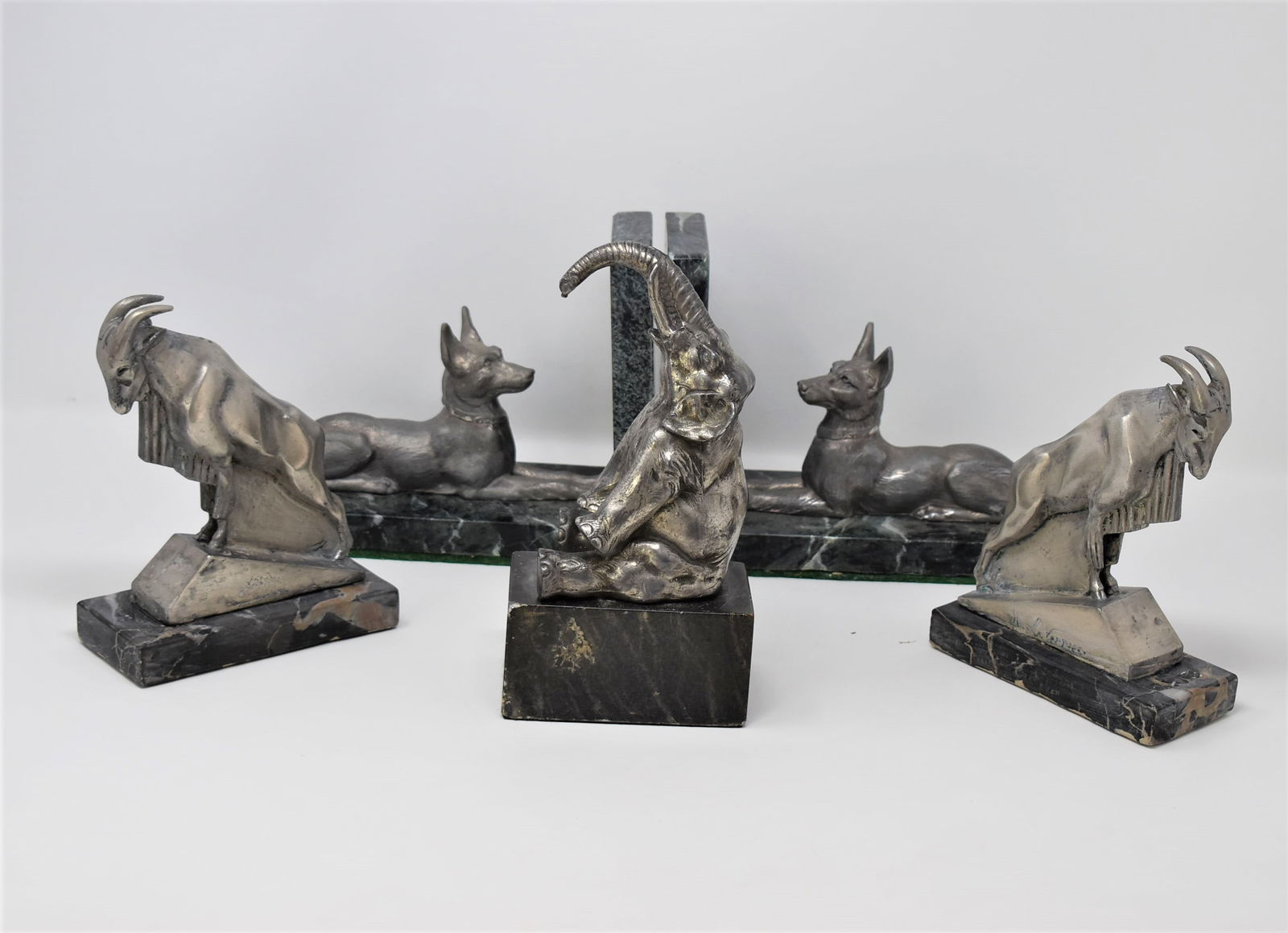 Grouping of Art Deco animal bookends: A grouping of Art deco spelter and marble bookends including a pair of dog bookends ( 6.25"h x 9"L x 3.75"D), a pair of goat bookends after Max le Verrier (6.75"h x 5.25"W x 2.25"D) , and a single ele