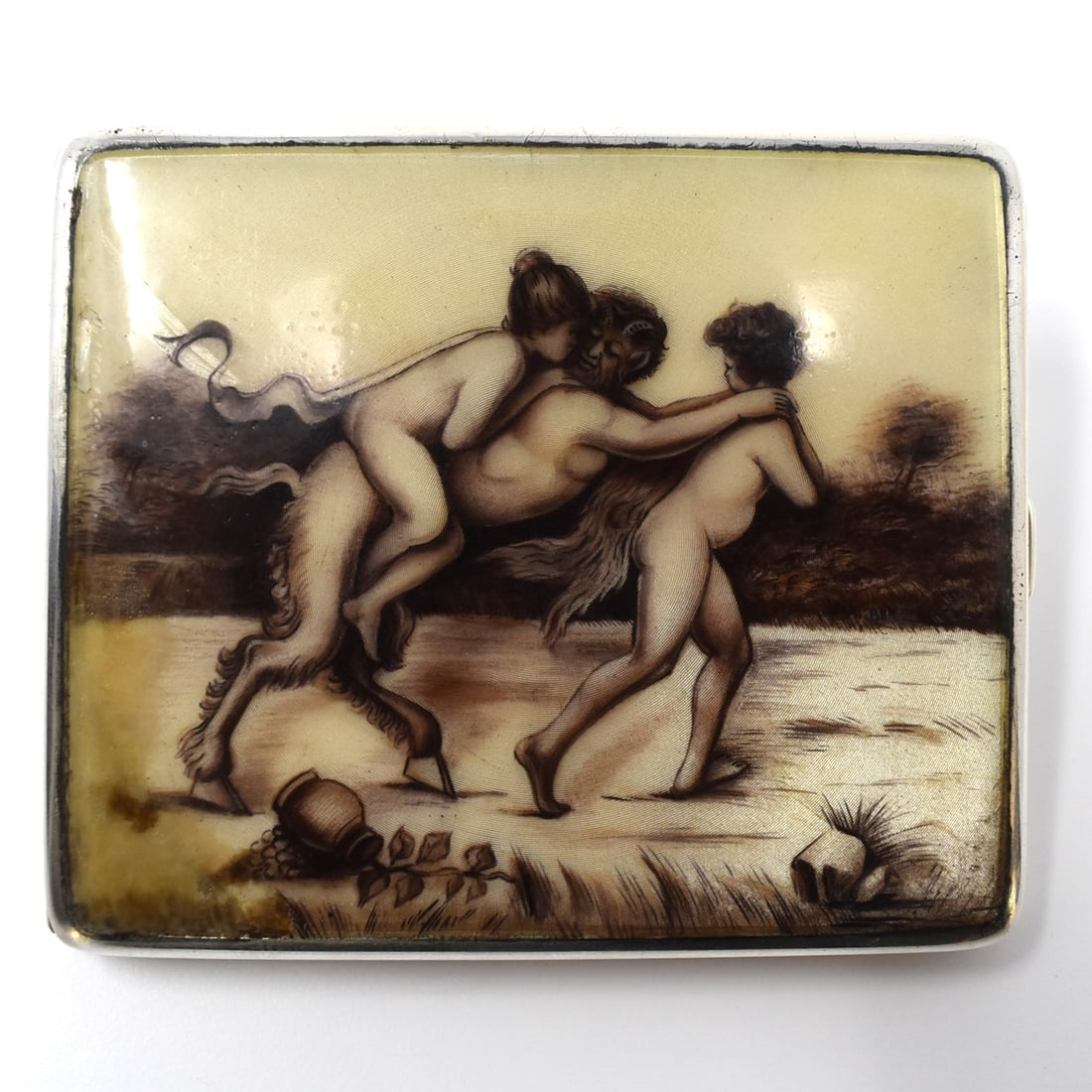 A German solid silver and enamel erotic 'satyr" cigarette case: An early Art deco German 800 silver enamel decorated cigarette case. The central hand painted ' en grisaille' enamel panel featuring an erotic scene with satyr. Circa 1920, stamped with german silver 