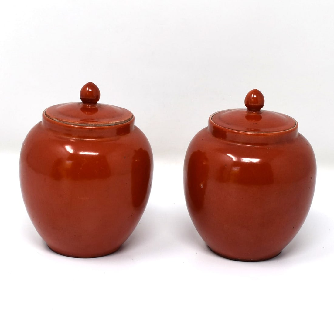 A small pair of Chinese copper-red glazed  porcelain covered jars (1 of 14)