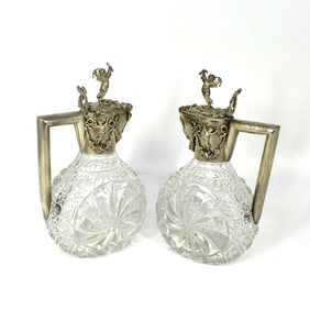 A pair of antique German .900 silver mounted claret jugs