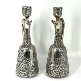 A pair of antique .900 silver overlay claret jugs