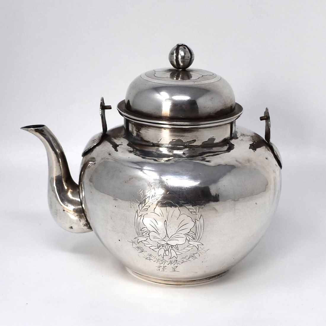 An antique Japanese silver teapot: An antique Japanese silver teapot missing its handle. Apparently un-marked but guaranteed to be silver of at least 800/1000 purity. Weight: 7 oz or 200g Approximate measurements: 5 1/2"H x 6"W x 4 3/4