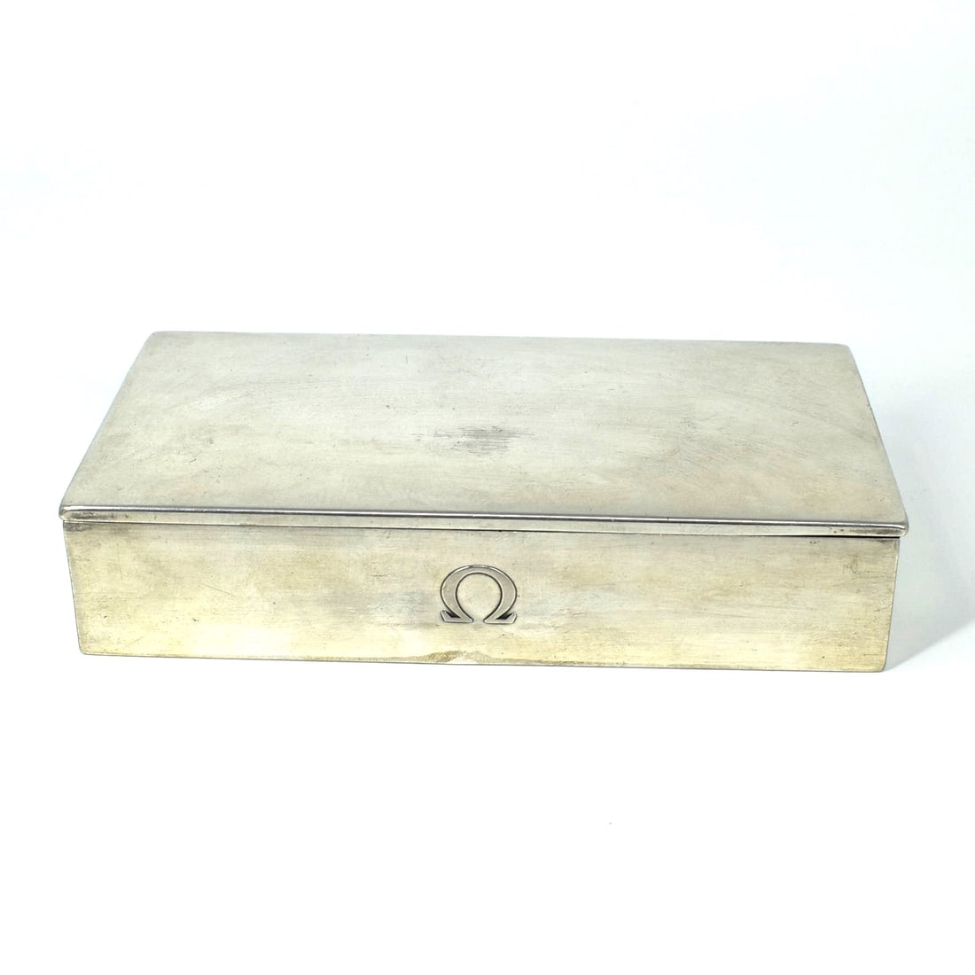 A vintage Swiss made silver cigar box: A vintage Swiss made .800 silver cigar box with fitted wood interior. Marked ' made in Switzerland", ' Tezler' and '800' for .800 silver. The front of the box with an 'omega' greek symbol. Circa 1950.