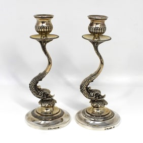 A pair of sterling silver Dolphin-form candlesticks