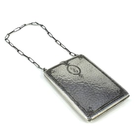 An antique Sterling silver compact case with chain & martele finish