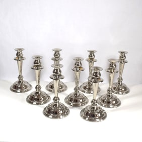 A grouping of 9 vintage silver-plated brass candlesticks