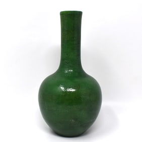 A Chinese apple-green glazed porcelain bottle vase with inscised decoration