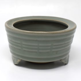 A Chinese celadon-glazed tripod censer