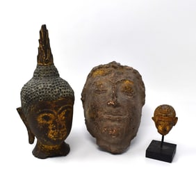 A grouping of antique or vintage Thai bronze and pottery Buddha heads