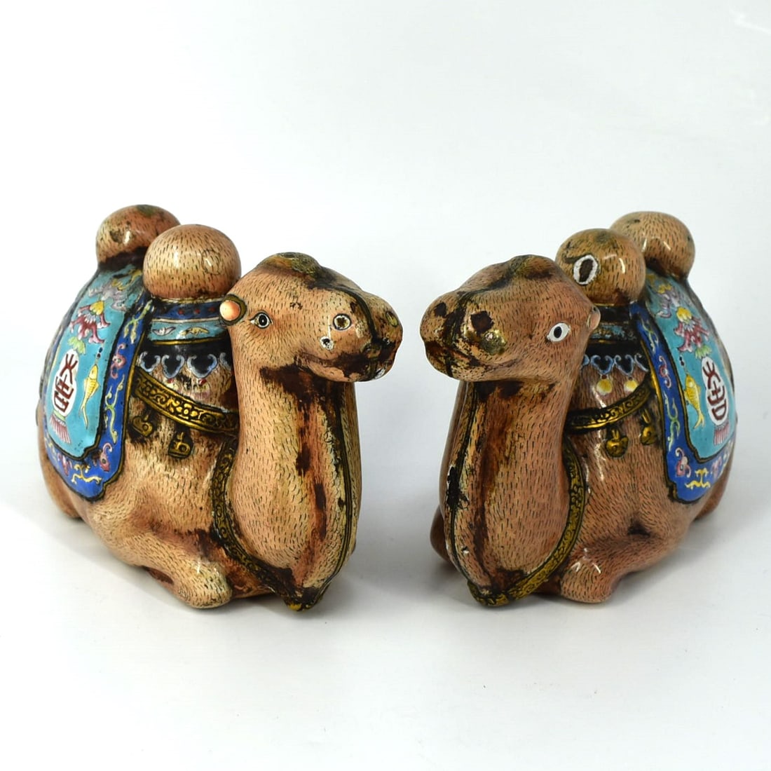 A pair of antique/ vintage Chinese enamel on copper camel figurines: An unusual pair of antique or vintage Chinese enameled copper figurines of crouching camels. Approximate measurements: 3 3/8"H x 6"W x 2 1/2"D or 8.5cmH x 15.2cmW x 6.3cmD