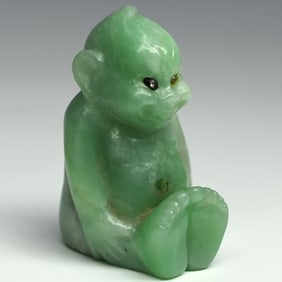 Attributed to CARTIER, a carved green hardstone Billiken figure