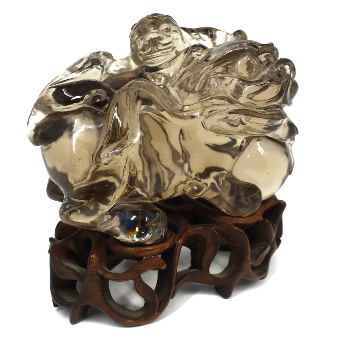 A Chinese carved smoky quartz figure of a Foo lion and cub: A Chinese carved smoky quartz figure of a Foo lion and cub on a carved wood custom base. Approximate measurements ( carved quartz only, base not included): 3 1/4"H x 4 1/2"W x 3"D or 8.2cm H x 11.5cmW
