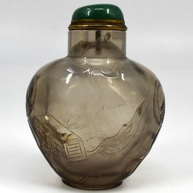 A Chinese carved smoky quartz snuff bottle