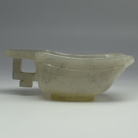 A Chinese archaistic celadon jade pouring vessel