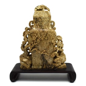 A Chinese carved stone vase and cover on custom base