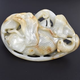 A Chinese celadon and russet jade fish carving