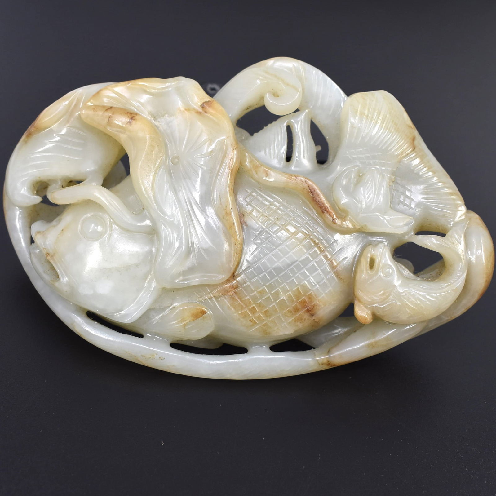 A Chinese celadon and russet jade fish carving (1 of 10)