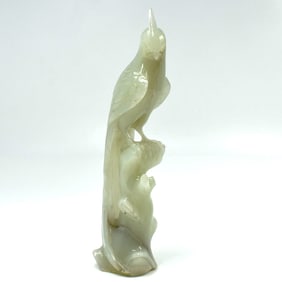 A Chinese jade carving of bird on stump