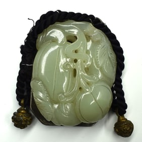 A Chinese carved jade plaque/ brooch