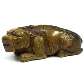 A Chinese stone carving of a reclining beast