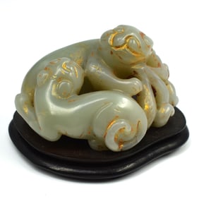 A Chinese carved jade group beast and cub
