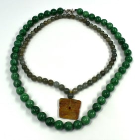 A grouping of two Chinese green stone bead necklaces