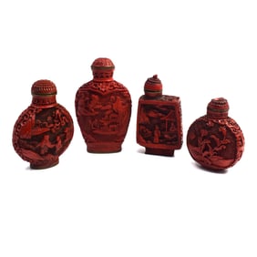 A grouping of four Chinese carved lacquer snuff bottles