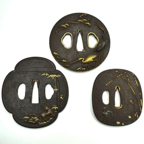 A grouping of three Edo period iron Tsubas featuring cranes and a tiger