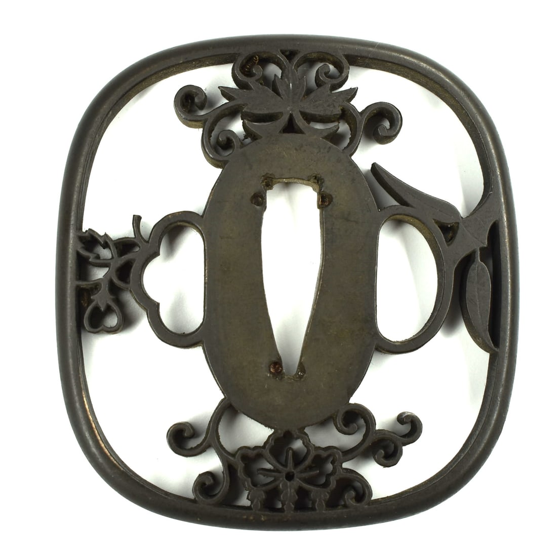 An Edo period brass sukashi tsuba: An Edo period brass sukashi tsuba with fine floral and fruit openwork motif. Un-signed. From an Ossining, NY private collection. Approximate measurements (largest Tsuba, for scale): 2 5/8"H x 2 3/8" W