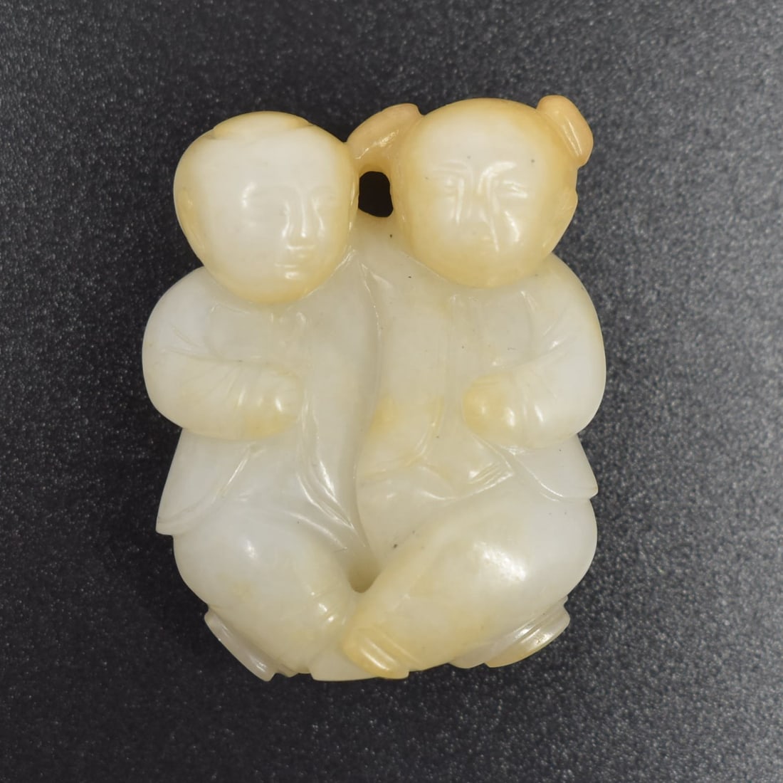 A Chinese jade carving of two boys: A Chinese jade carving of two boys. Approximate measurements: 1 5/8"H x 1 3/8" W or 4cm H x 3 .5cm W