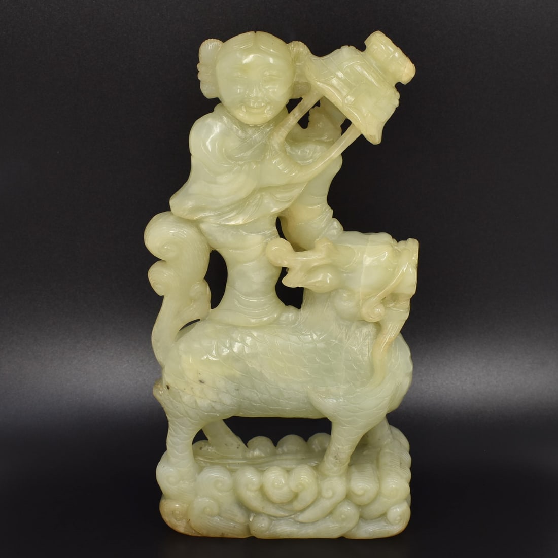 A large Chinese jade/stone carving of a boy riding a Qilin (1 of 13)