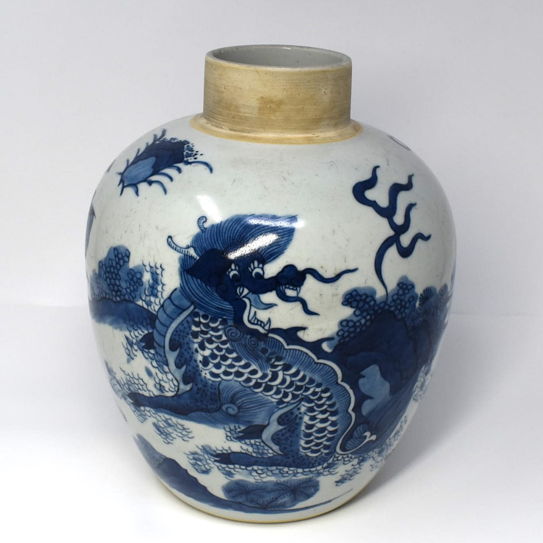 A Chinese blue and white dragon jar: A chinese blue and white porcelain jar with continuous underglaze motif featuring dragons/beasts in landscape. From an Old Westbury NY estate. Approximate measurements: 9 3/4"H x 8 1/2" in diameter or