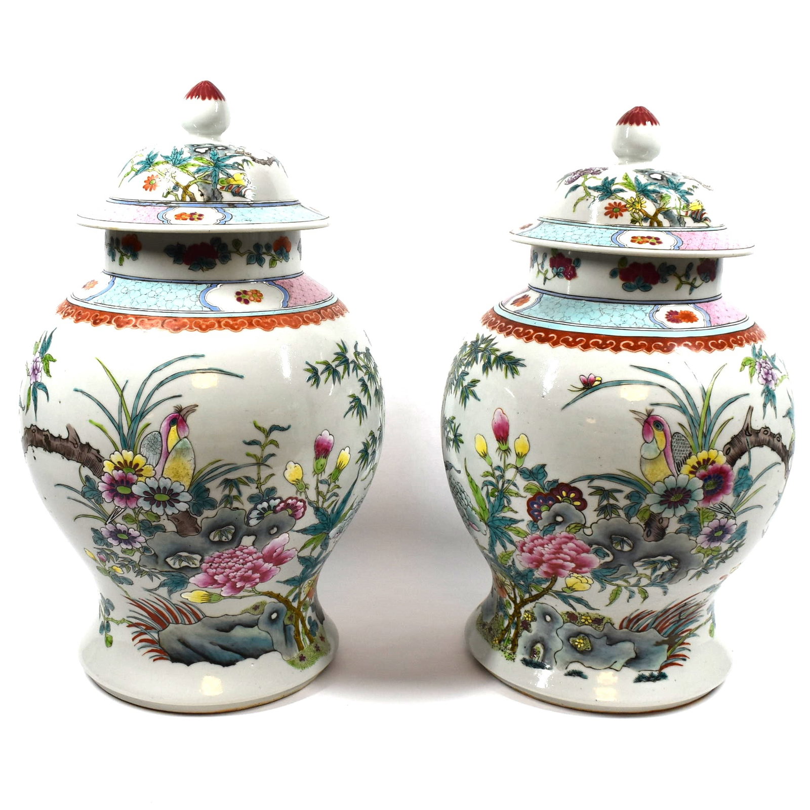 Large pair of Chinese famille rose porcelain vases and covers: A large matching pair of Chinese famille rose porcelain vases and covers, decorated with flowers birds and insects. 19th /20th century. From an Old Westbury NY estate. Approximate measurements: 17"H x