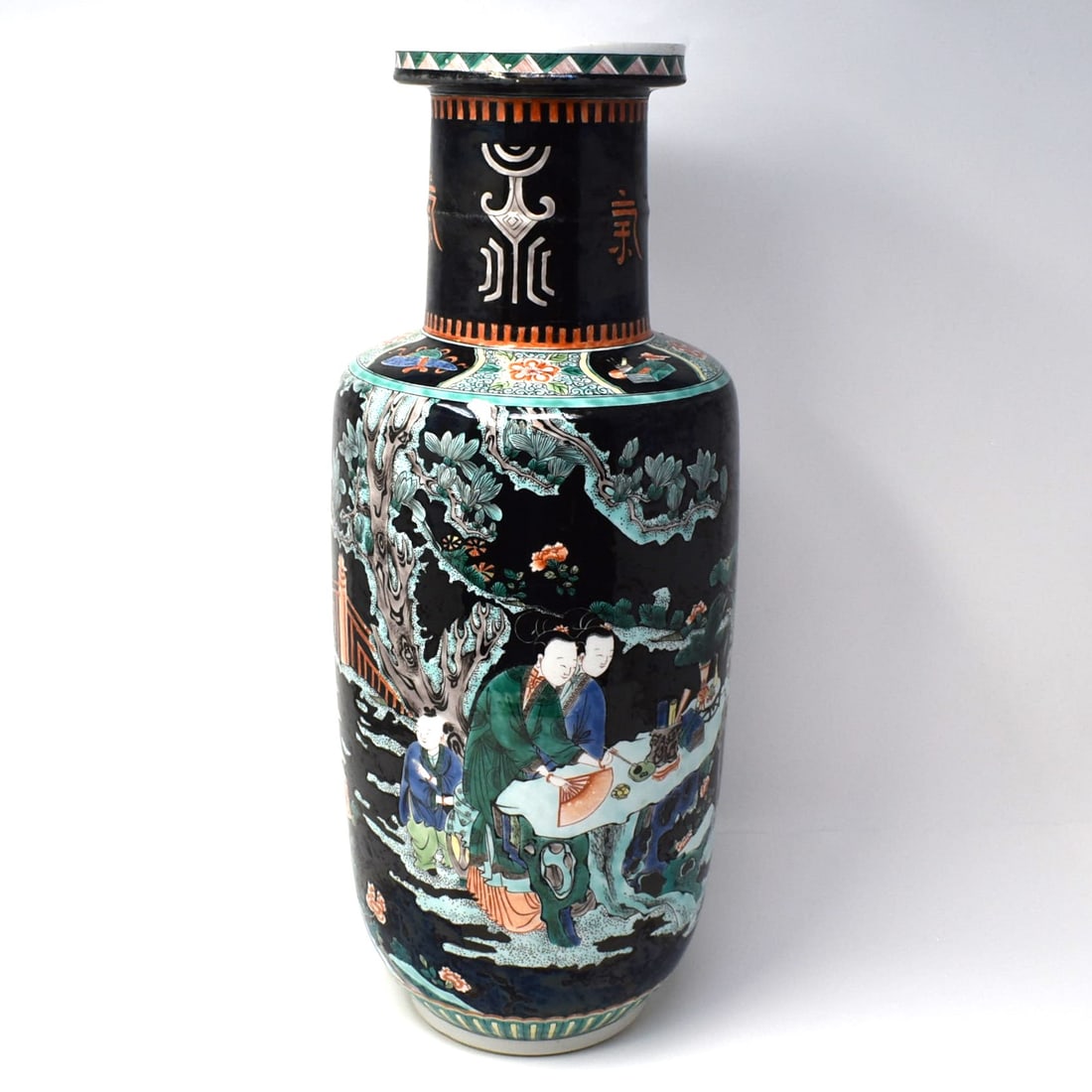 A Chinese Famille Noire rouleau vase: A large chinese famille noire porcelain rouleau vase, with continuous decoration featuring women and children in palatial gardens. Late Qing Dynasty. From an Old Westbury NY estate. Approximate measur
