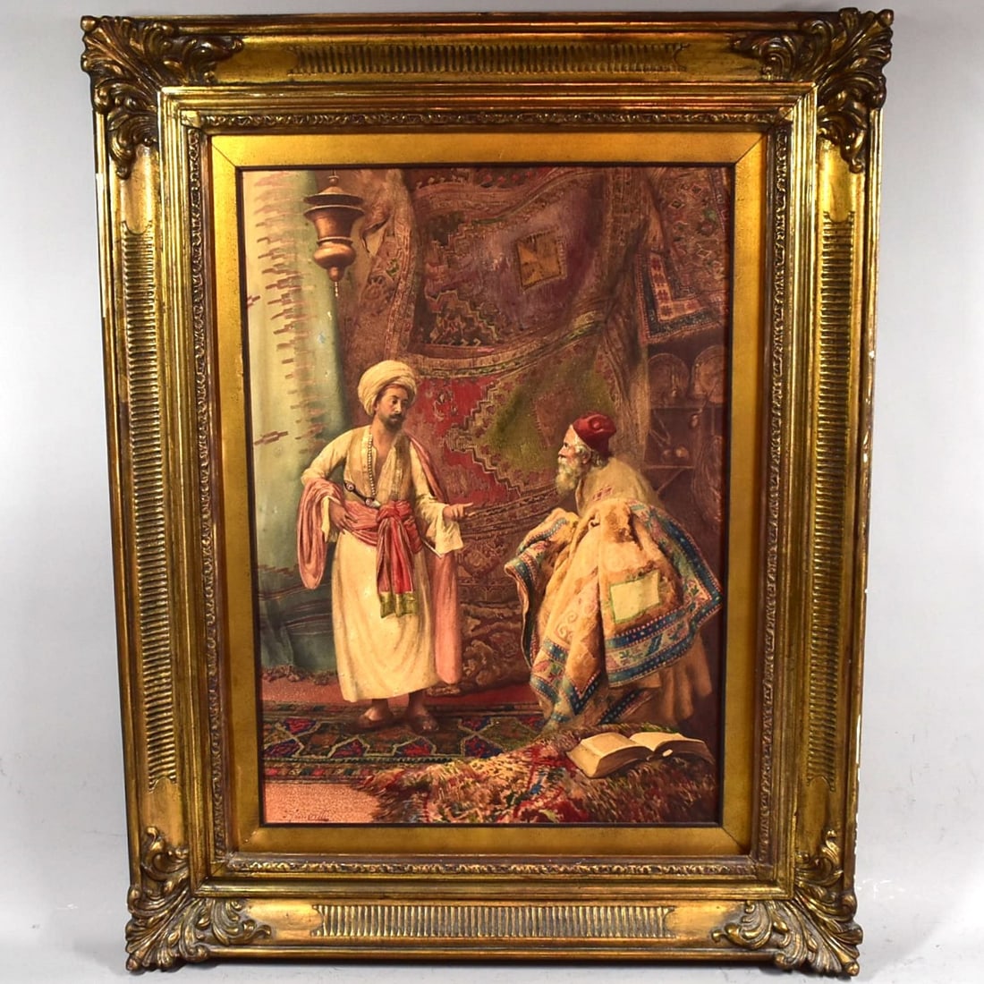 Umberto CACCIARELLI (1880-1939) Orientalist watercolor on paper 'Rug Dealer': A very competent late 19th century Orientalist gouache on artist board depicting a rug dealer and a potential client conversing, signed 'Cacciarelli' lower left for Umberto Cacciarelli (Italian, 1880-