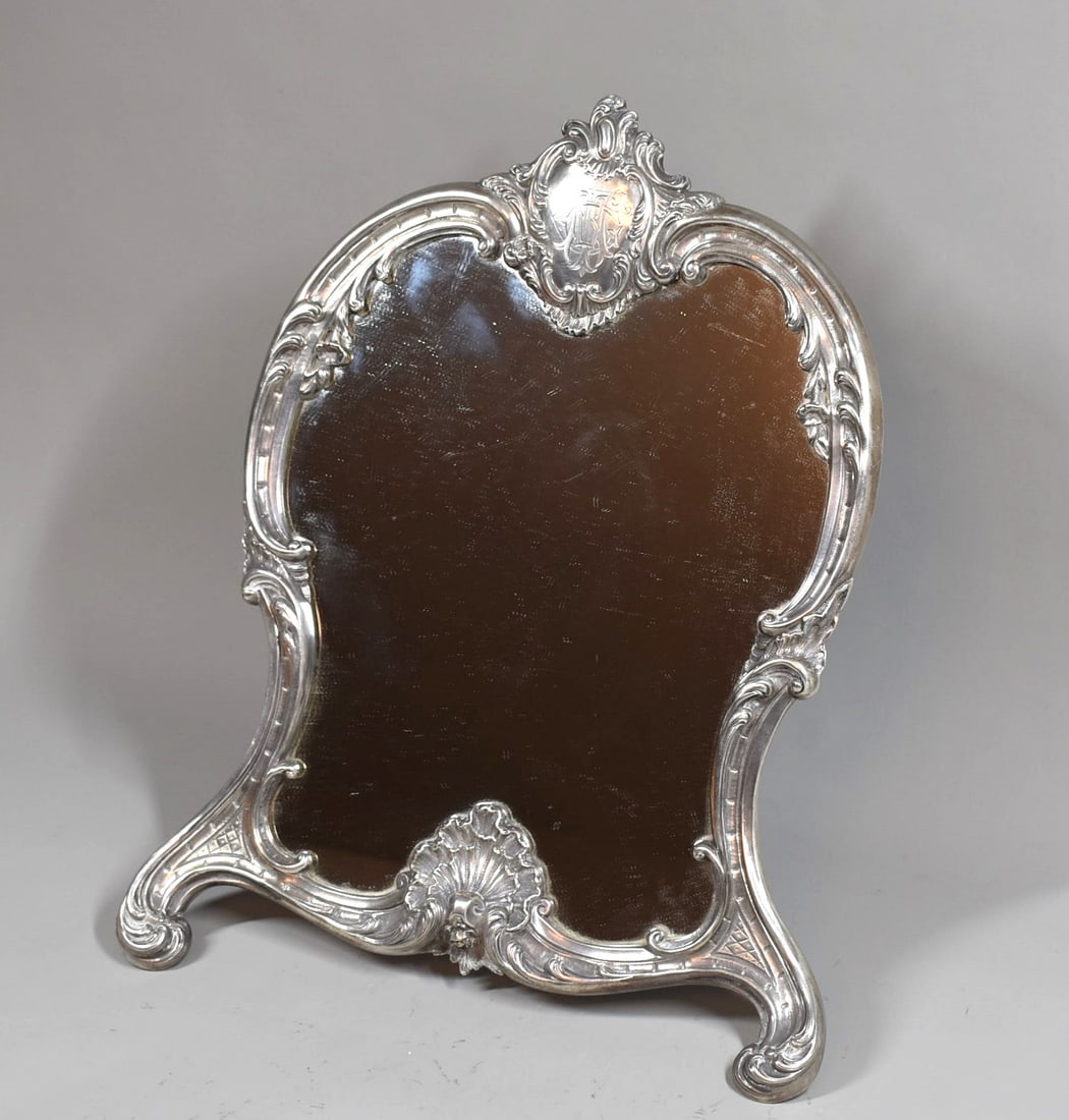 Antique French sterling silver Rococo style table mirror circa 1900: A fine antique French sterling silver mounted Rococo style easel-back table mirror with silver plate and wood easel back circa 1900.The silver mounts stamped with first grade silver (.950 silver) Merc