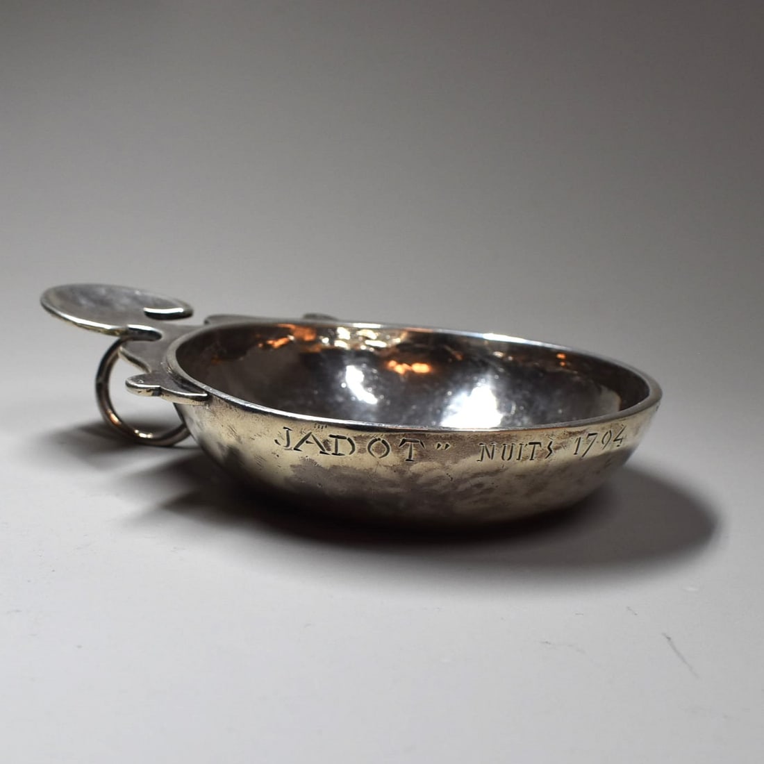 An antique French silver wine tester, 'tastevin': An antique French solid silver wine tester, 'tastevin' inscribed ' Jadot Nuits 1794' ( Likely refers to a famous Pinot Noir, Cote de Nuits, Burgundy, France, which was tested in this cup). 19th centur