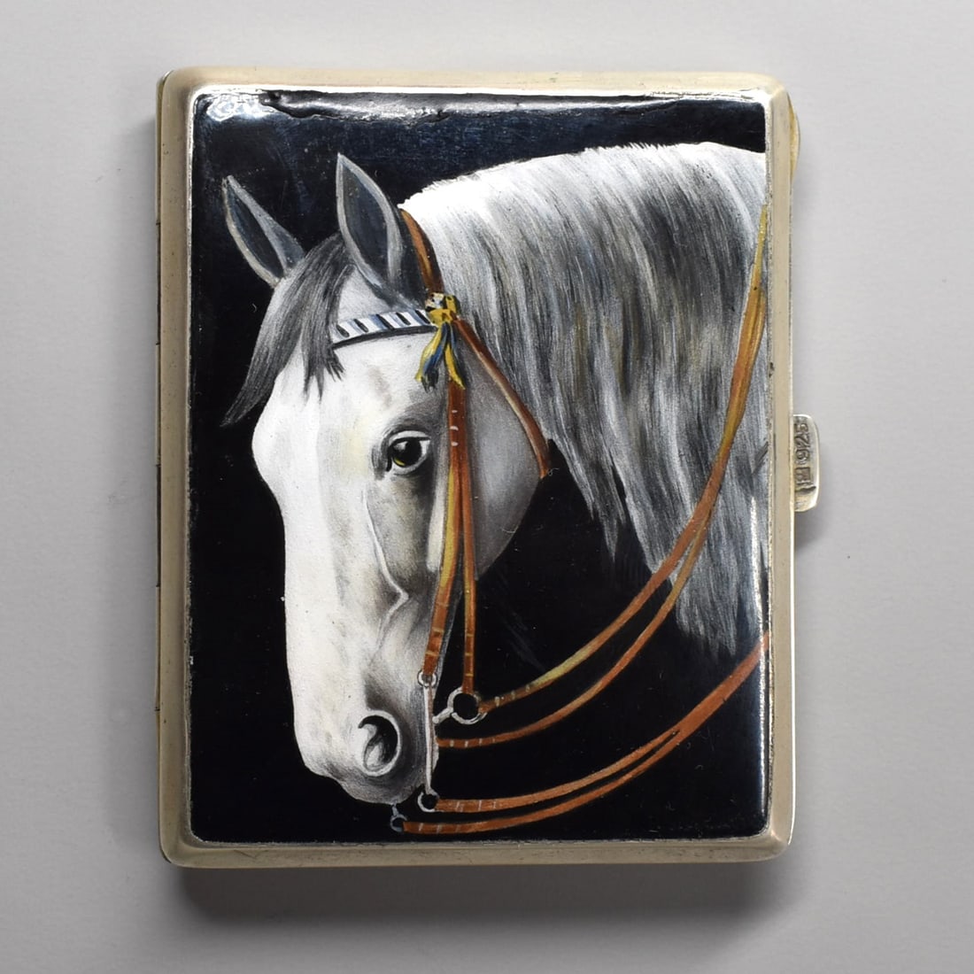 A German Art Deco sterling silver cigarette case with Equestrian motif: A German Art Deco sterling silver cigarette case with Equestrian motif, circa 1930.The top of the case hand painted with a horse head on a black ground. The opening latch with German silver hallmarks
