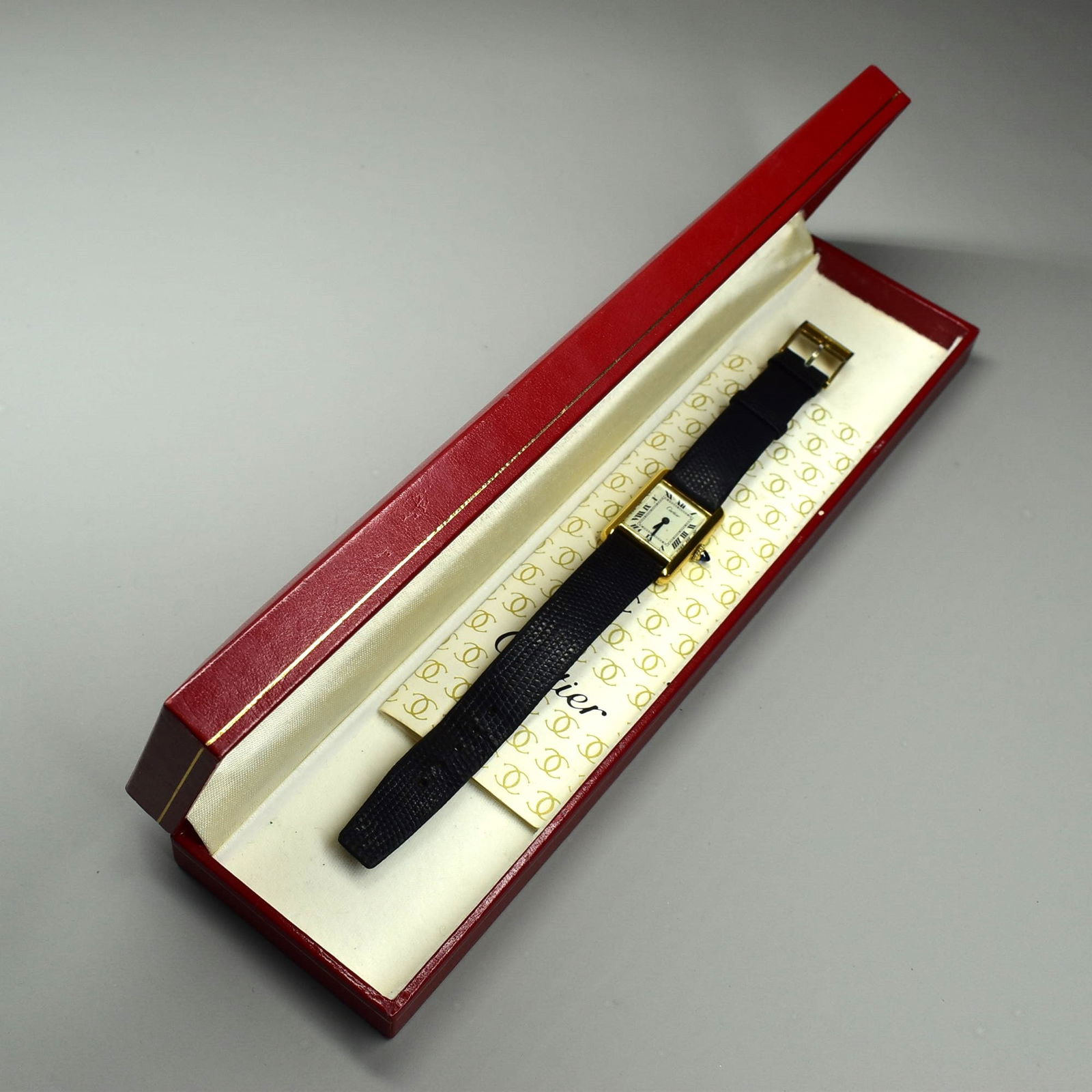 A Vintage 1976 CARTIER Lady's gold-plated Tank Wrist Watch: A Vintage CARTIER Lady's gold-plated Tank Wrist Watch, with original faux Lizard Cartier leather strap and buckle, the back marked 'Cartier, Plaque Or G20M' and numbered 108500. With original Cartier