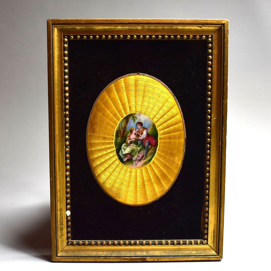 Antique guilloche enamel and enamel miniature painting on copper, framed: An antique French (?) guilloche enamel and enamel miniature painting on copper plaque featuring an 18th century style courting scene. Framed. Circa 1900. Approximate measurements: 8 1/2"H x 6 1/8"W or